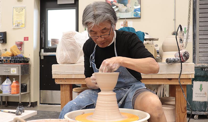 Mr. V. Chin making a ceramic bowl.